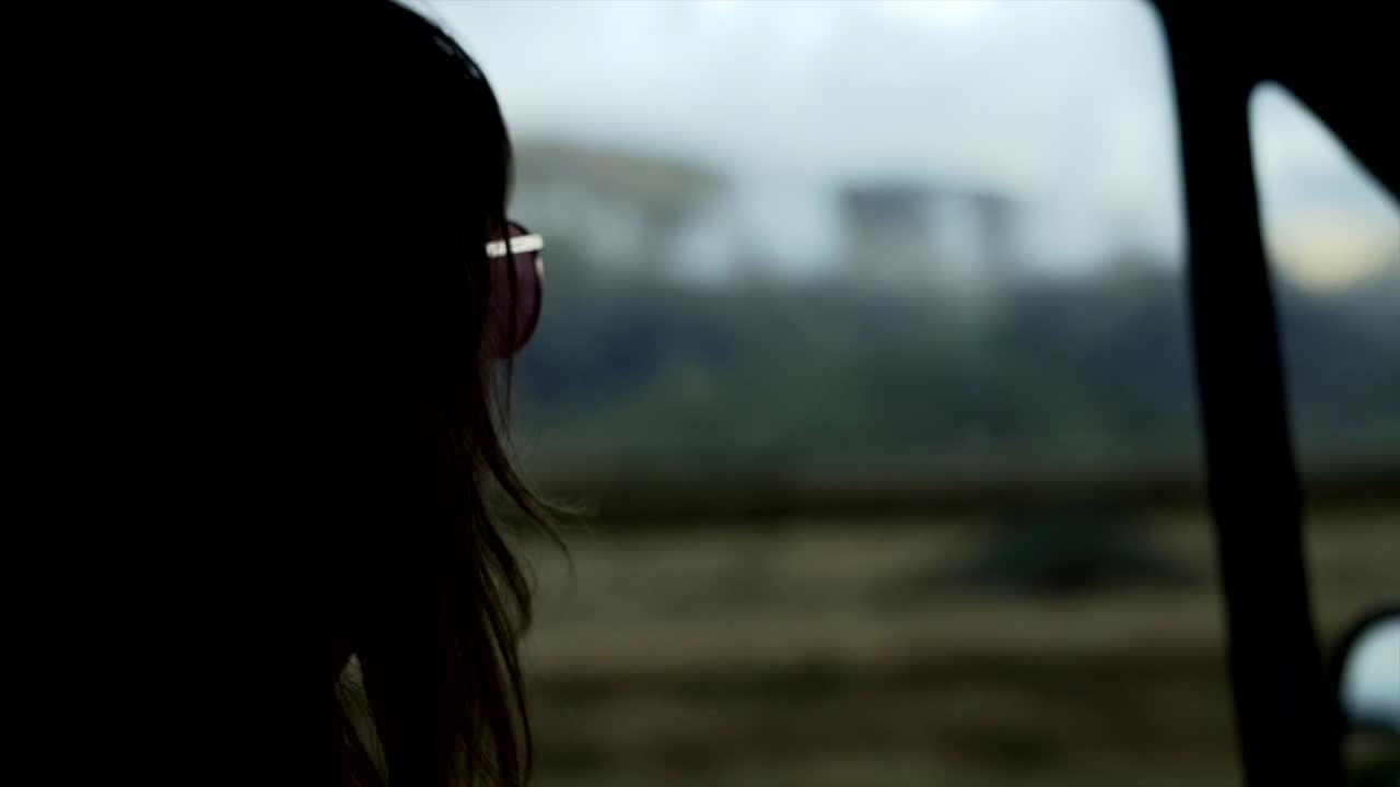 Woman's Silhouette Looking Out Car Window