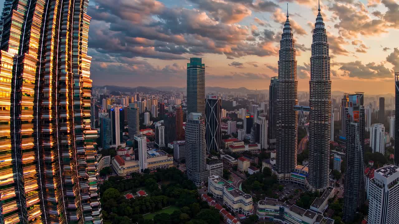 Aerial video captures a panoramic view of a city skyline at sunset ...