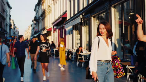 people shopping and walking on a busy city street