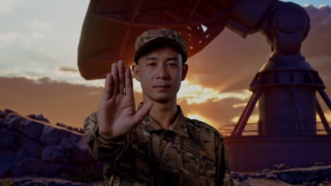 Close Up Of Asian Man Soldier Looking At Camera And Disapproving With No Hand Sign While Standing With Satellite Dish