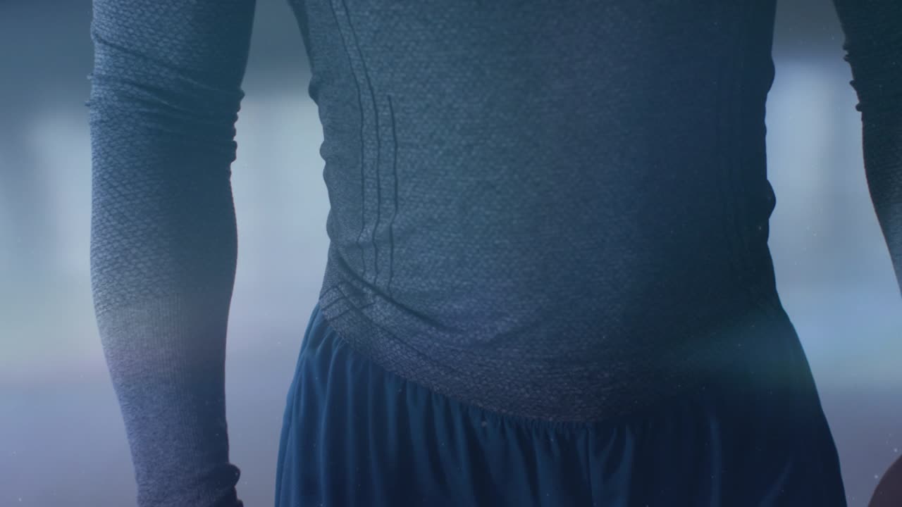 Male torso standing while camera shifting up, light streaks revealing seams and fabric for fashion