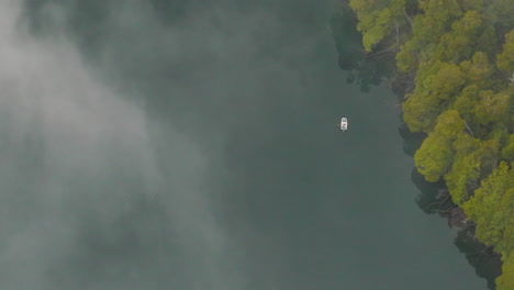 breathtaking bird's eye view of a small fishing boat on the rio manso in argentina