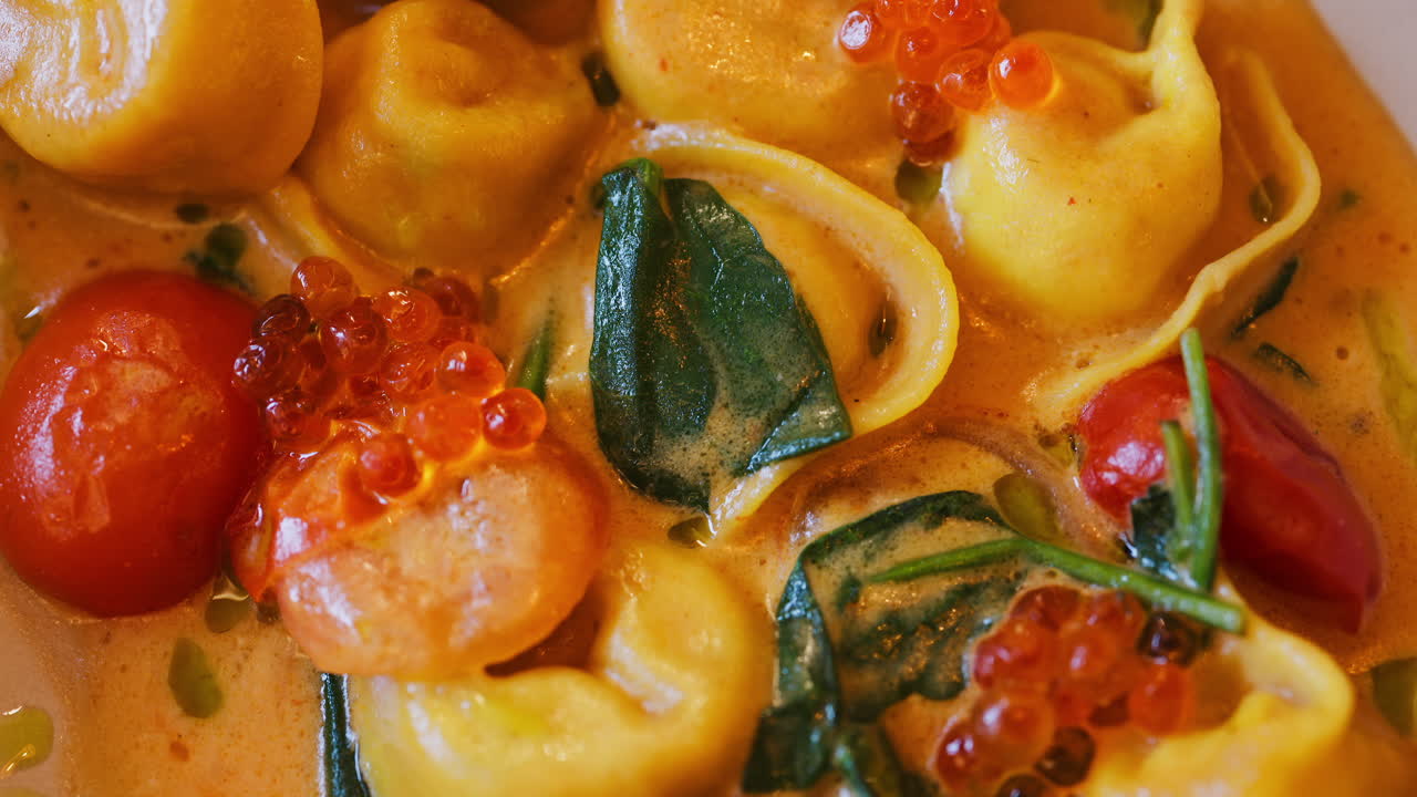 Close up of a ravioli dish with seafood and sauce at a restaurant