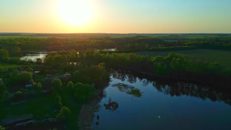 Aerial---Scenic-drone-over-green-landscape-with-winding-river-at-sunrise