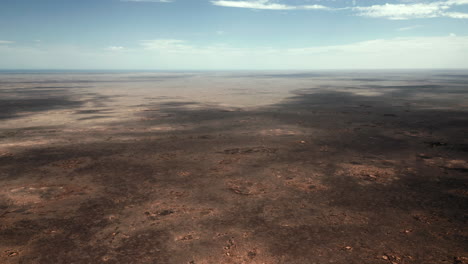 Aerial-view-overlooking-endless-bare-nature,-the-desert-and-Australian-outback---pan,-drone-shot