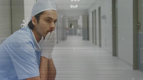 Composite-video-of-tv-static-effect-against-stressed-male-worker-at-hospital