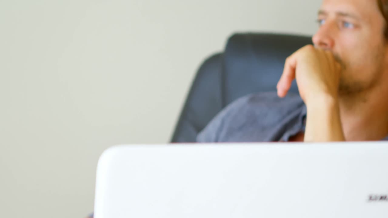 Man relaxing in living room at home 4k