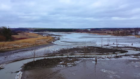 water pollution. narrow river floating among dirty background of nature in spring.
