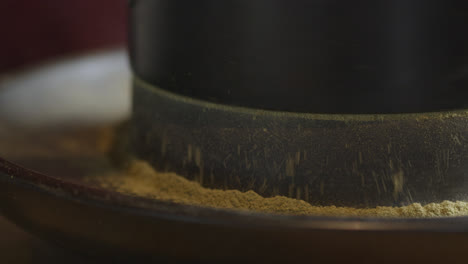 grinding tea with a traditional grinder preparing the traditional chinese tea ceremony