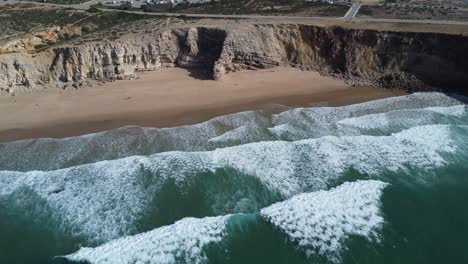 big waves rolling at tonel beach near sagres in southern portugal, perfect sunny weather