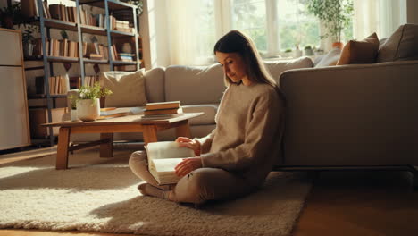 woman reading book in cozy living room