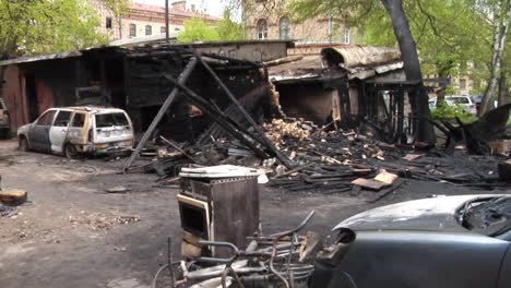 remains of a burned house and car destroyed by a house fire