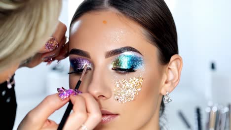 makeup artist applying glitter makeup