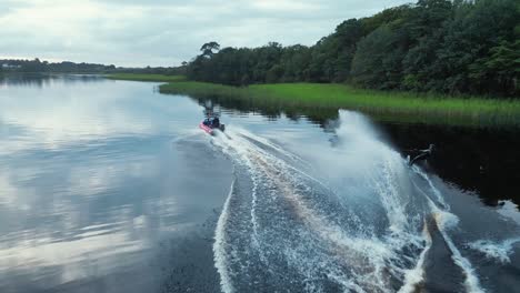 a waterskier cutting on a slalom ski aerial shot