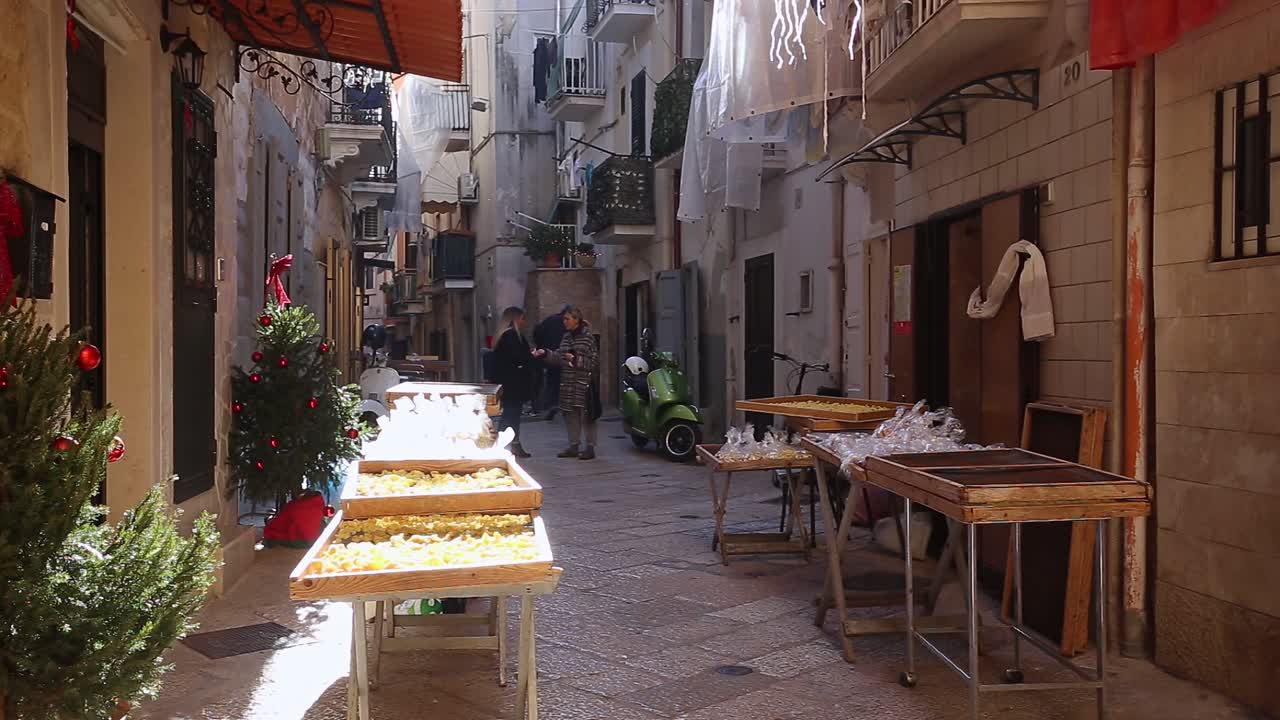 People walking on the narrow beautiful streets on Bari, Italy