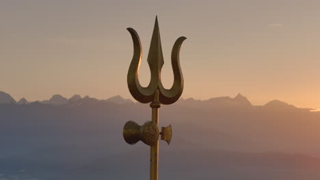 sunrise over mountains with trishul (shiva's trident)