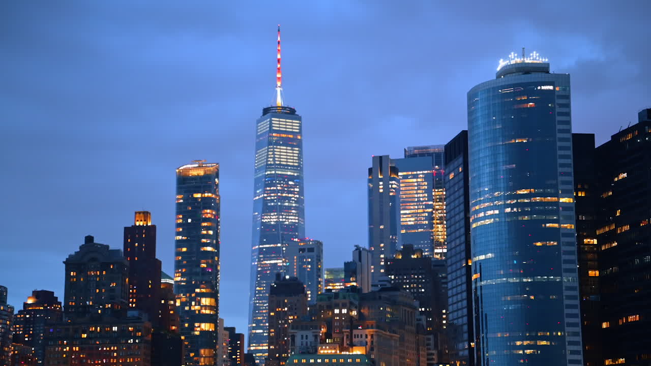 View on the tops of high-rises and skyscrapers with bright illumination. Low angle perspective. New York architecture at dusk time