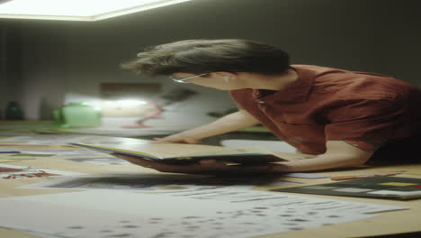 young man working or studying creatively at a desk