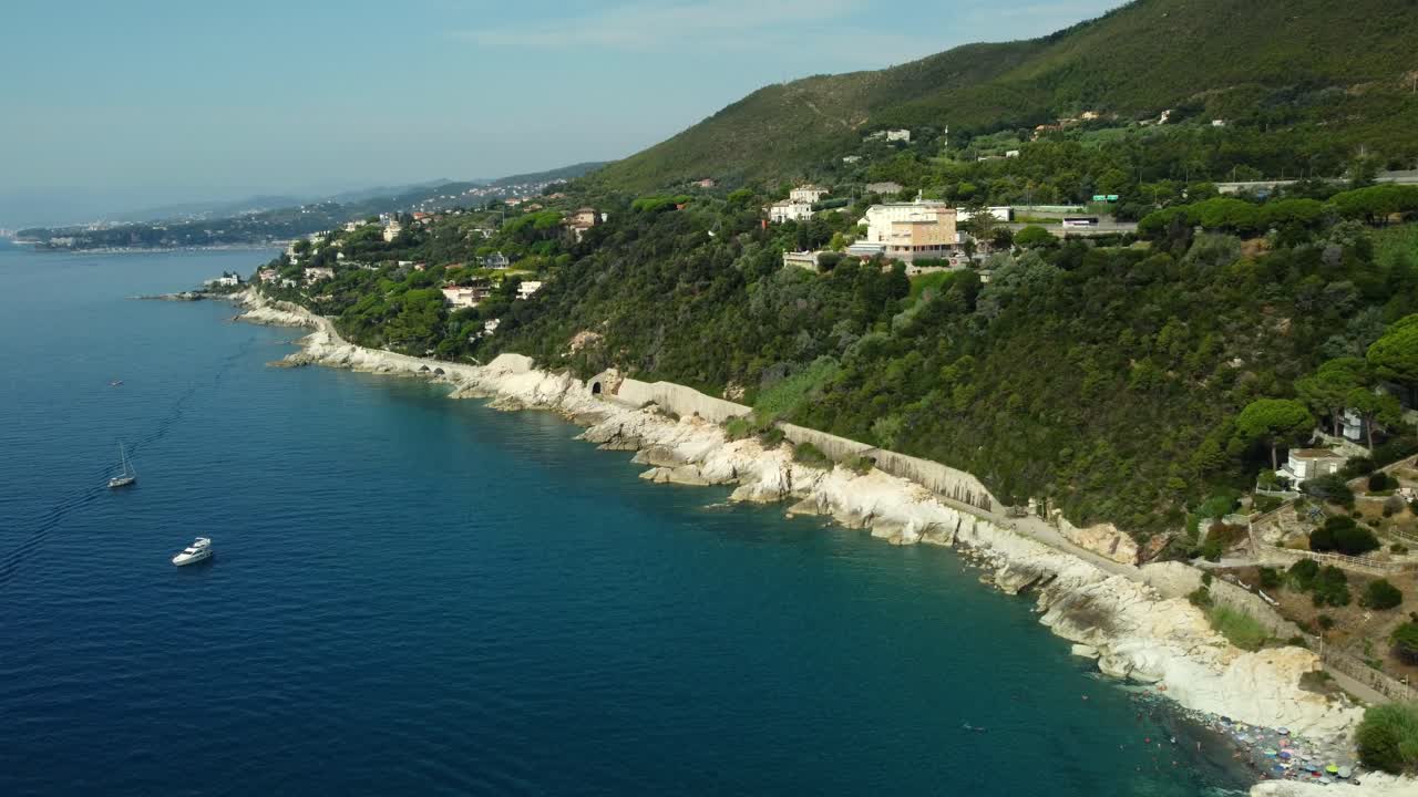 Aerial view of coast and sea with houses, mountains and boats