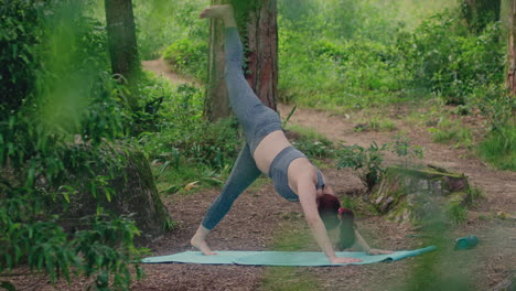 girl practices yoga one leg in the air