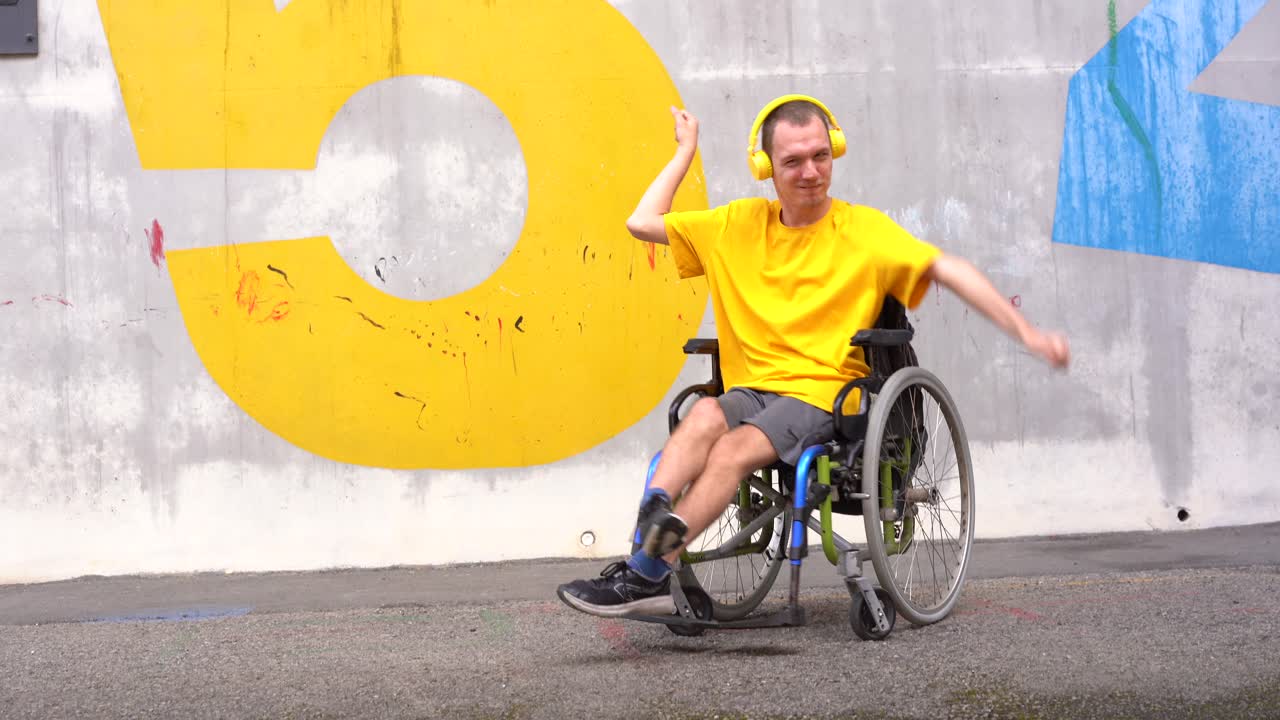 Man in Wheelchair Dancing with Headphones