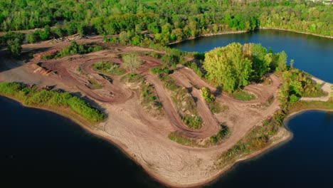 orbiding aerial above large dirt bike tracks on island