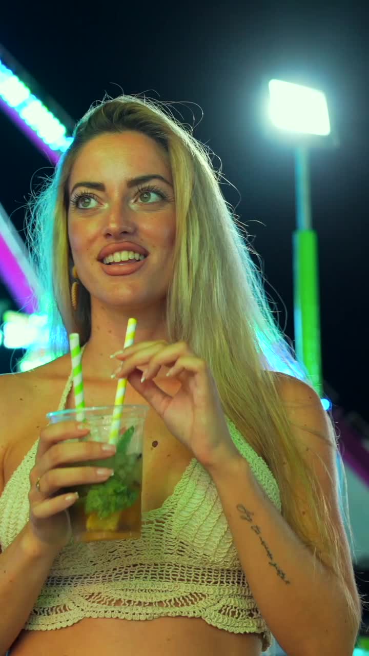 Woman enjoying a cocktail at a fair