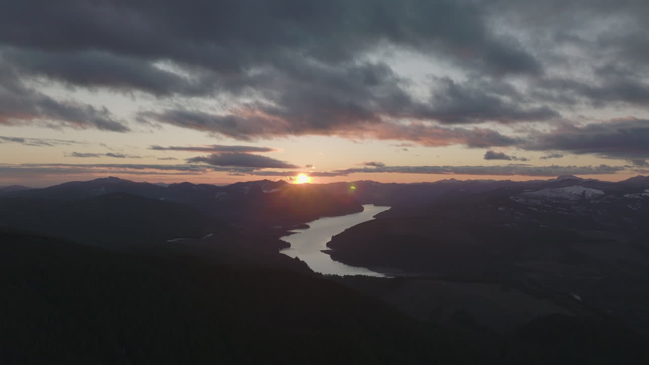 Slow pan across Swift Reservoir from McClellan Viewpoint in Gifford Pinchot National Forest, Washington State, during vibrant sunset.