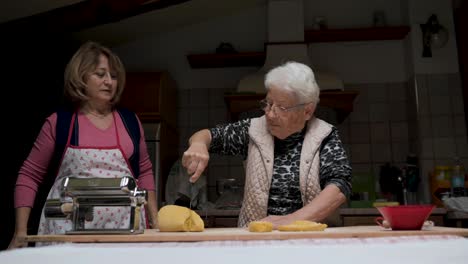 Aged-women-cooking-tortellini-together-in-kitchen