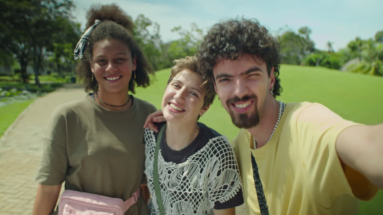 POV of Happy Young Friends Taking Selfie in Park