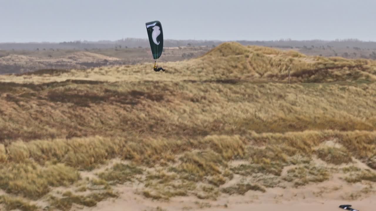 Kiteboarding over Sand Dunes at the Beach
