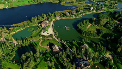 aerial birds eye shot of natural nature reserve area with hotel and leisure activities - amatciems,lativa