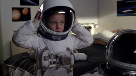 a young boy in an astronaut suit prepares for his space adventure in his bedroom