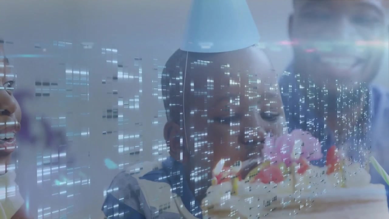 Happy Boy Blowing Out Birthday Candles with Family and Digital Data Overlay