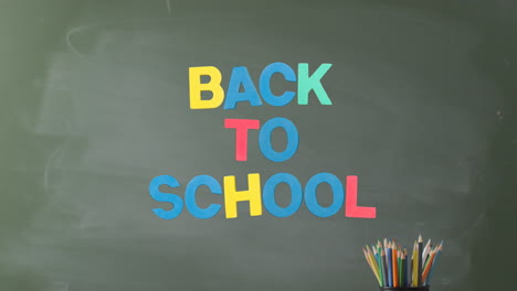 animation of back to school text over pencils on grey background