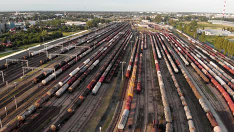 aerial shot showing large train depot with many colorful cargo trains