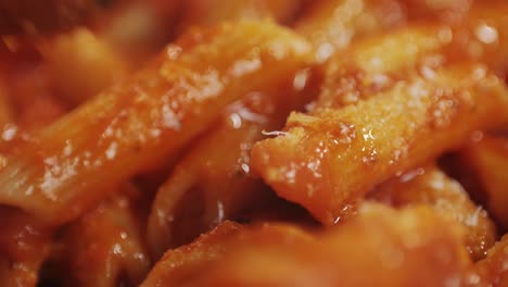 cooking traditional arrabbiata pasta, penne with tomato sauce close-up. cook classic homemade italian tomato sauce for pasta and pizza in the pan. chef cooks traditional italian food. high quality 4k footage