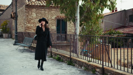 elegant woman having a business call in the streets of a small town