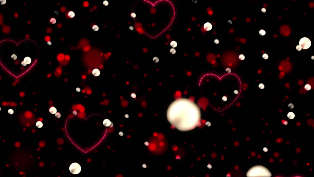 animación de un corazón rojo que cae y manchas brillantes sobre un fondo negro