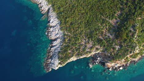 beautiful ionian sea shoreline in albanian riviera, with green hills, rocky formations, and emerald sea