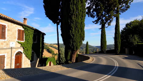 winding road through italian countryside with cypress trees