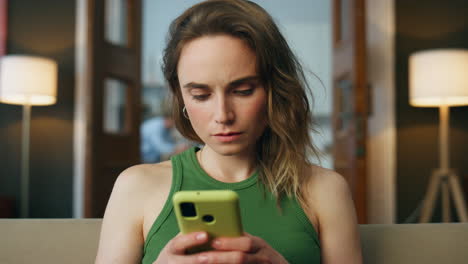 Focused lady messaging smartphone at home zoom on. Closeup woman texting phone