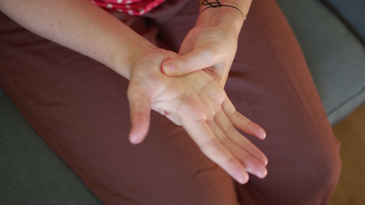 Woman Massaging Her Palm And Hands. - high angle shot