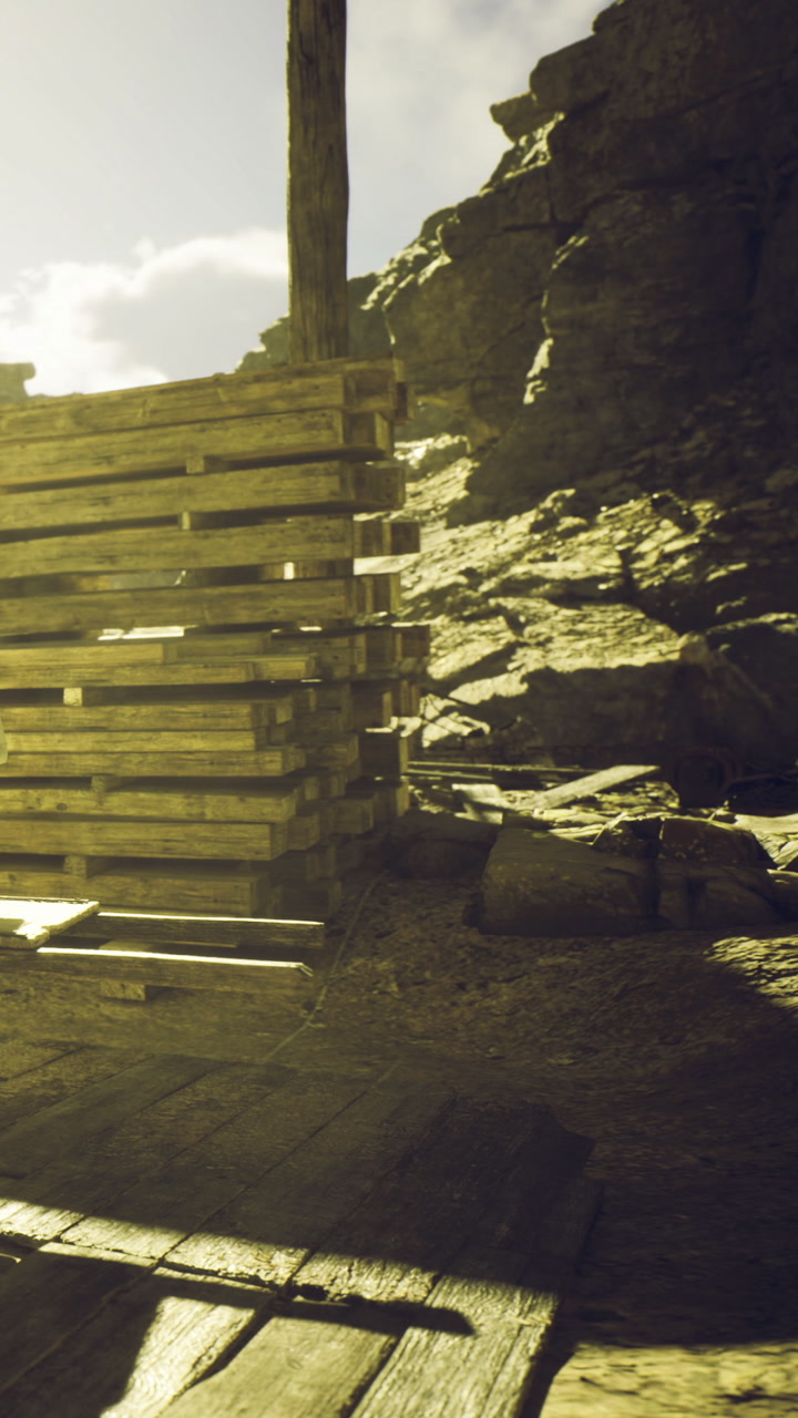 Wooden pallets stacked against rocky terrain under the warm sun