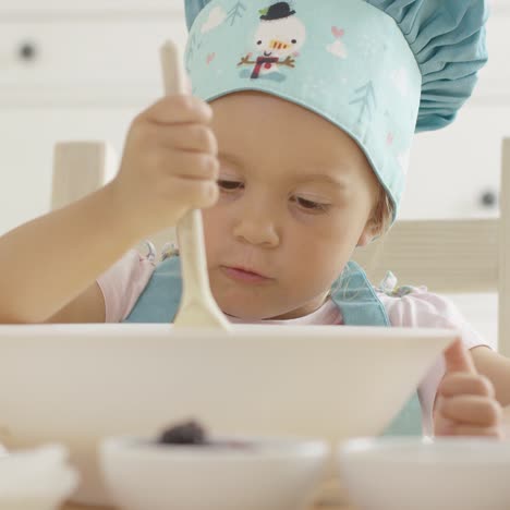 Adorable-serious-toddler-at-mixing-bowl