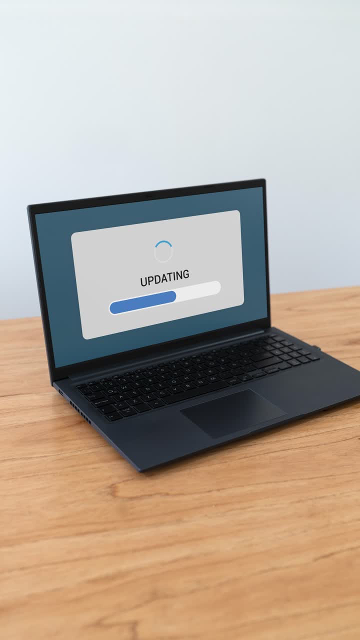 Vertical shot of updating process on laptop screen. Concept of new software.