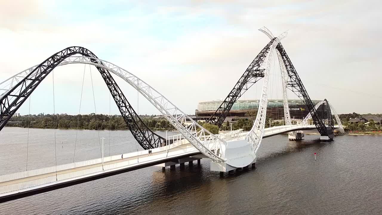 Aerial ascending view of pedestrians crossing the Matagarup Bridge towards Perth Stadium