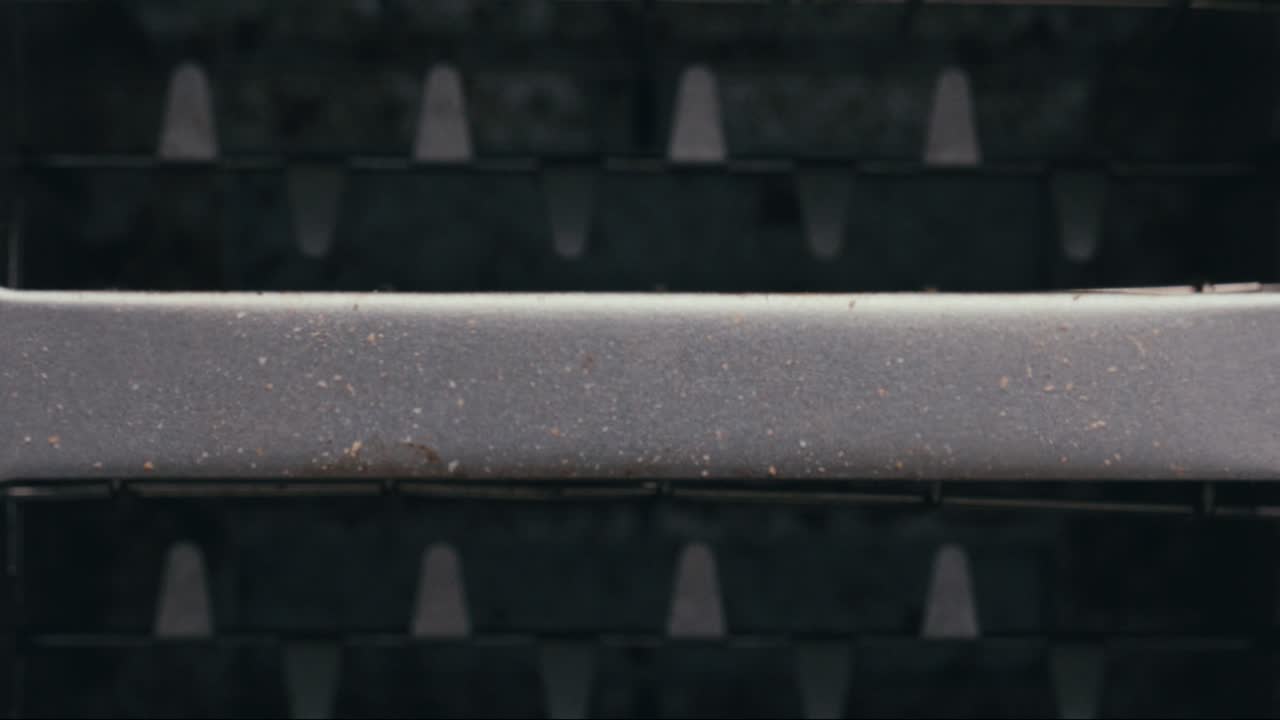 Hand Taking Crisp Bread Slices from Toaster after Browning