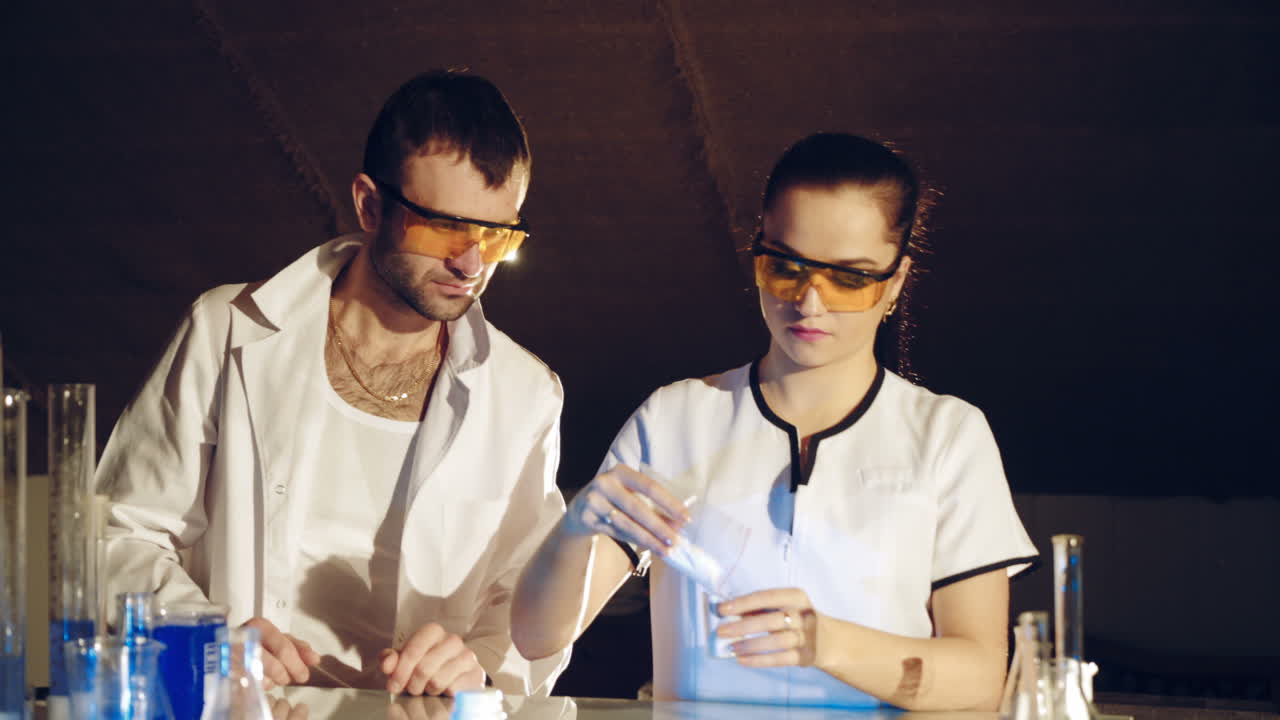 Chemistry students working on an experiment together in college. Research in the chemical laboratory