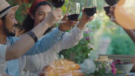 multiracial couple making toast celebrating with friends at reunion dinner party drinking wine sitting at table chatting sharing lifestyle people relaxing outdoors 4k footage